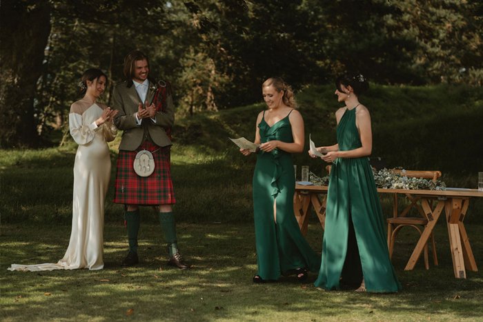 Wedding Readings By Bridesmaids Wearing Green During An Outdoor Wedding Ceremony At Hartree Estates