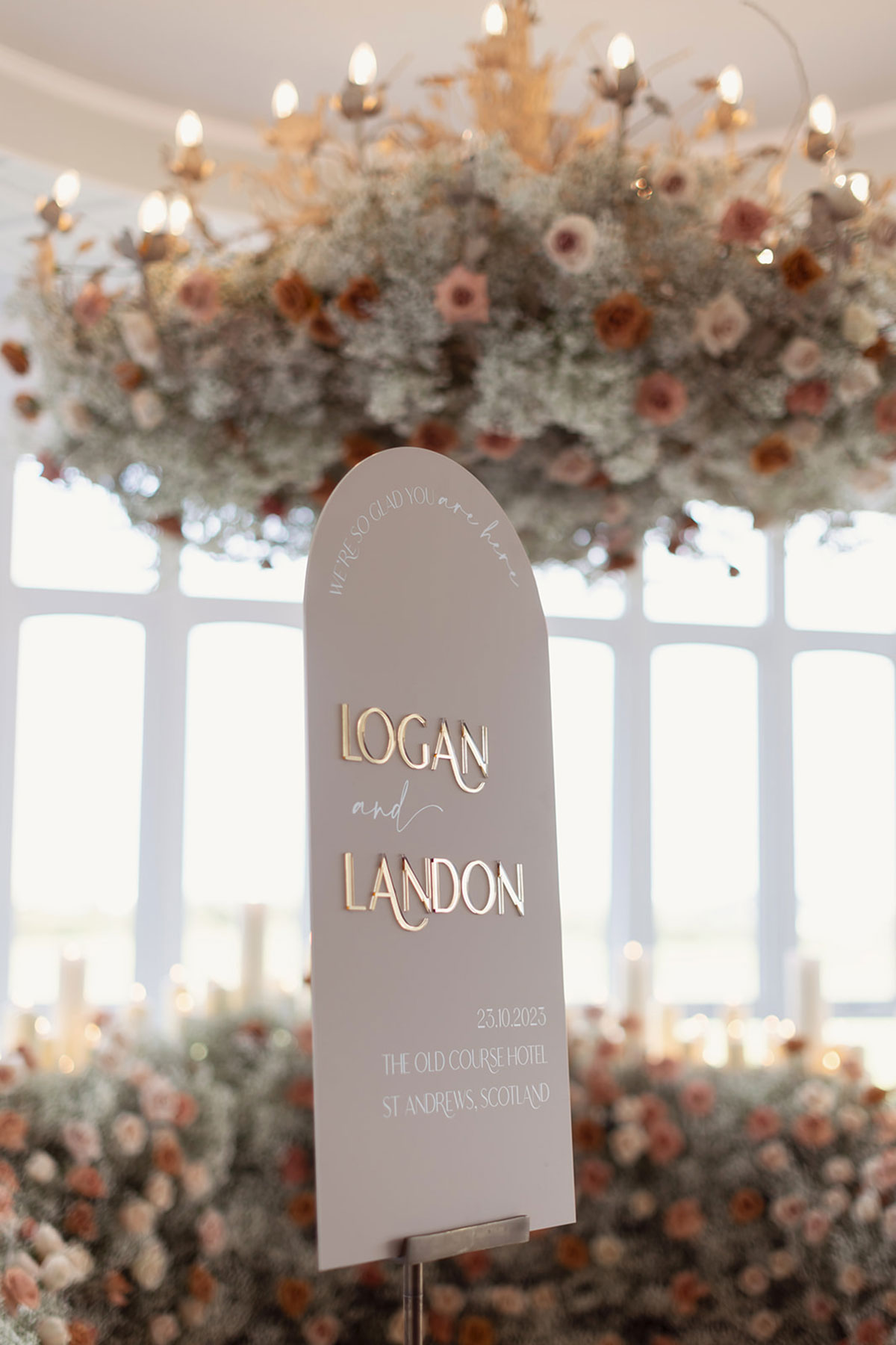 Modern wedding sign with gold lettering reading “Logan and Landon” at Old Course Hotel Conservatory wedding, St Andrews