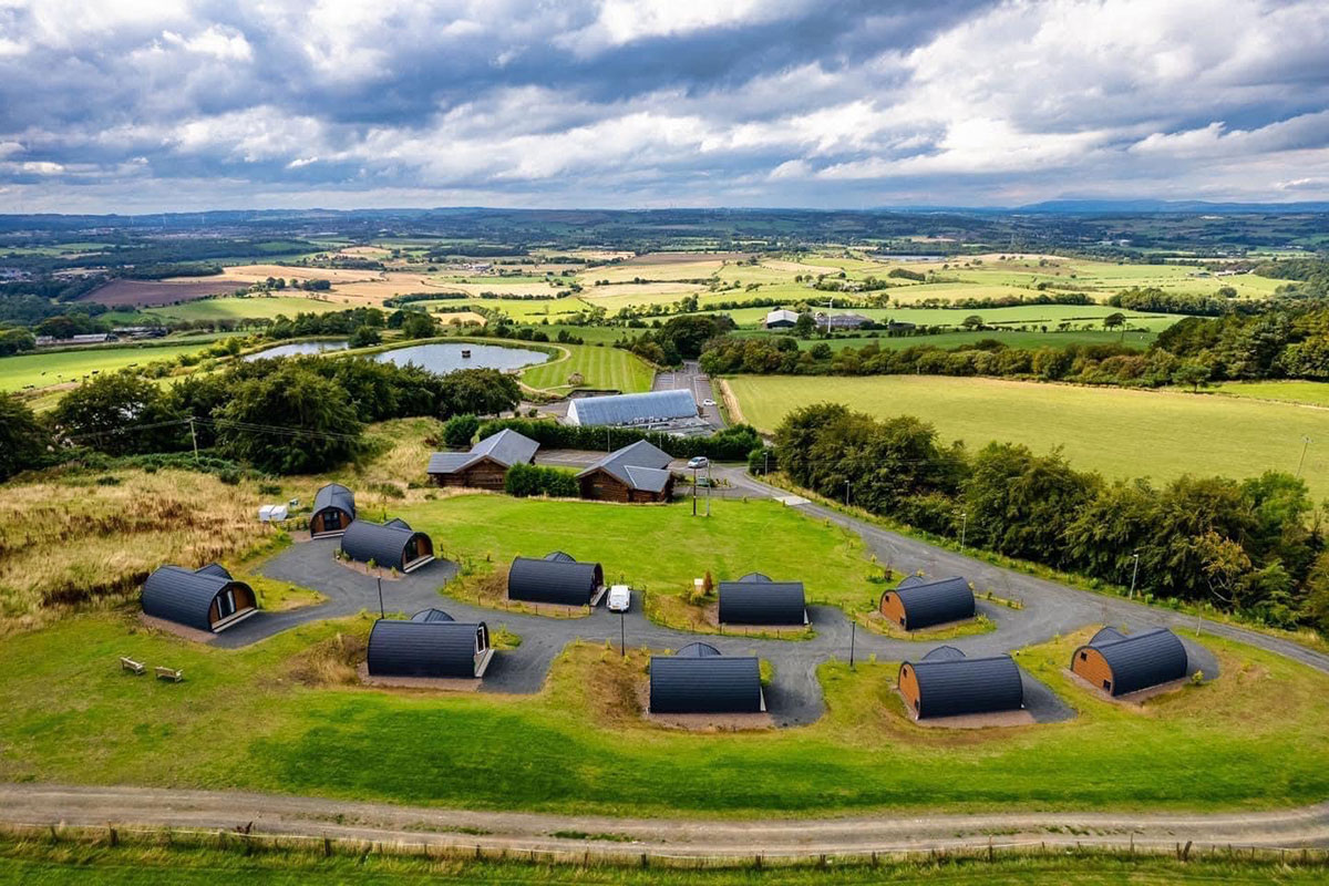 Aerial view of The Vu in Bathgate showing the Snugs accommodation, surrounding countryside and reservoir