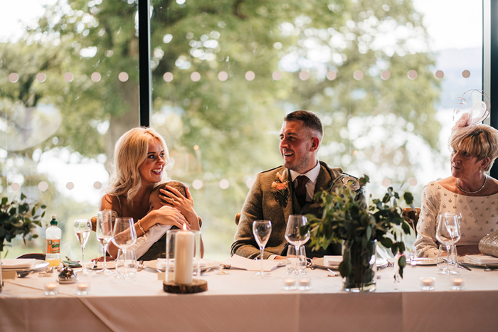 Bride and groom sit at top table