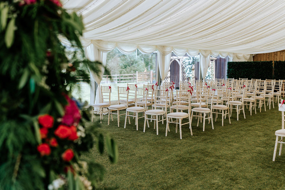 ceremony set up with white chairs and red ribbon at eden leisure village in cumbernauld