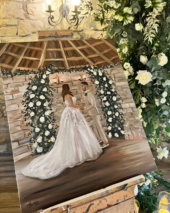 a painted canvas portrays a bride and groom holding hands in front of a white floral arch