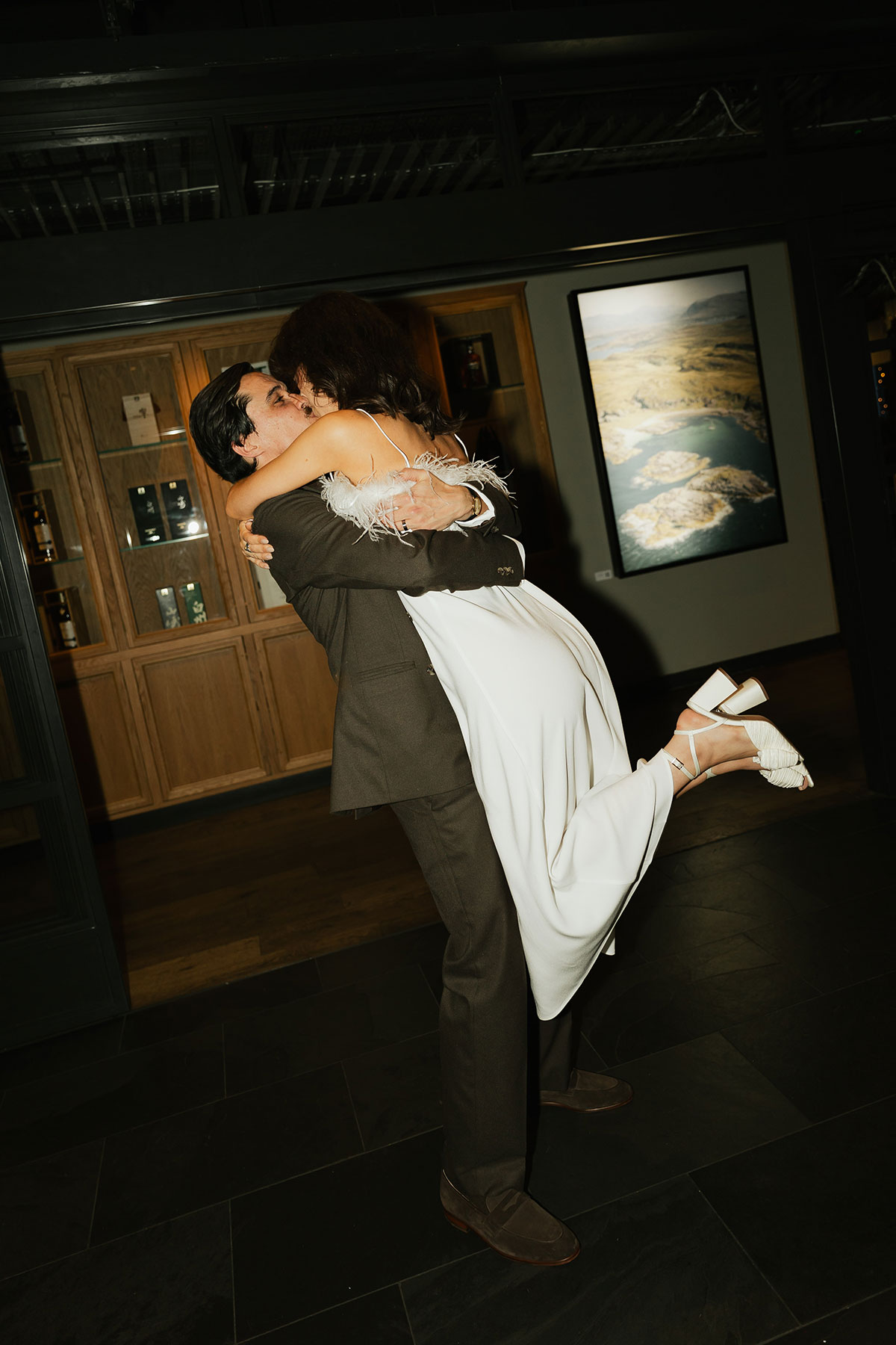 Groom lifting bride during evening celebrations at Gleneagles Townhouse wedding.