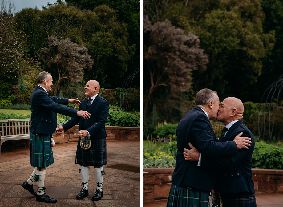 two grooms kissing during their first look in the ornamental garden at Brodick Castle