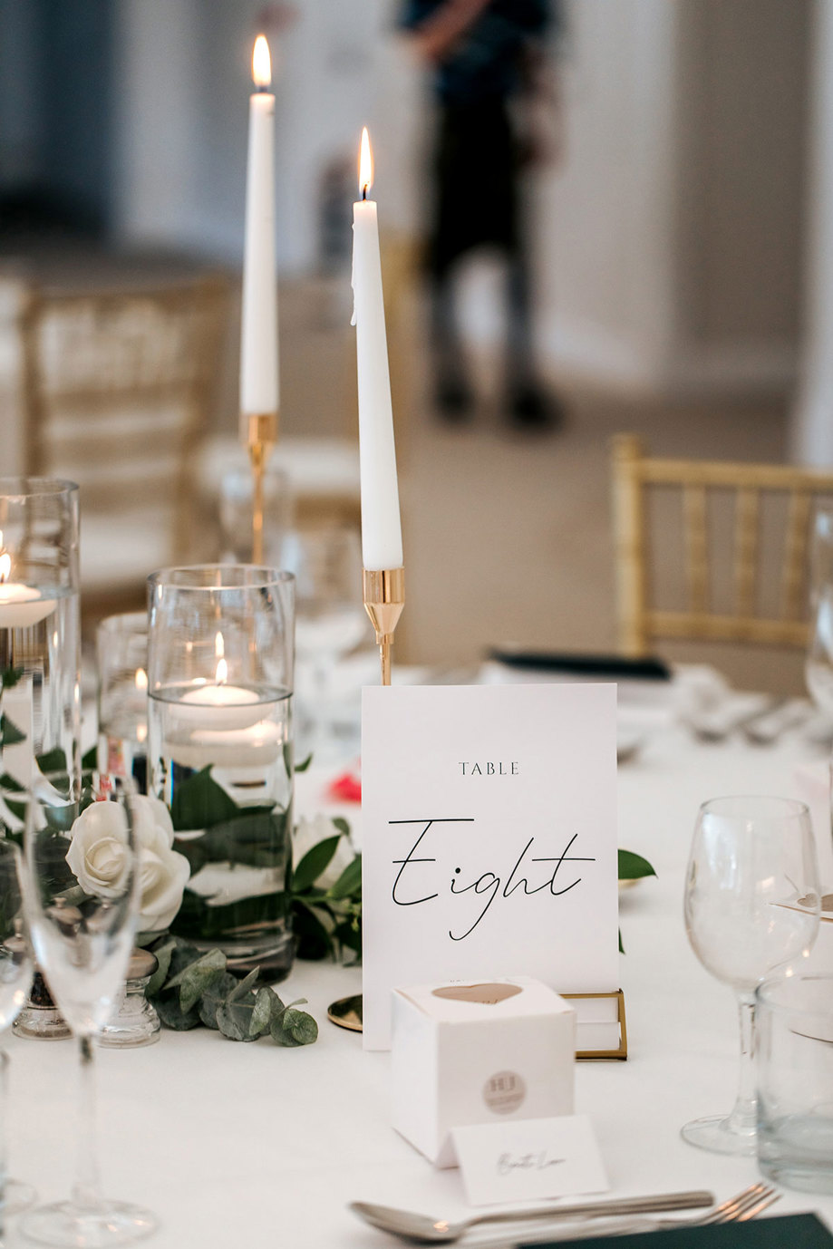 dinner table set up for wedding at mar hall with sign reading table 8 in focus