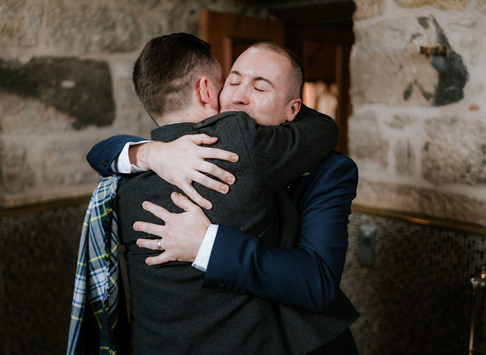 two grooms hugging