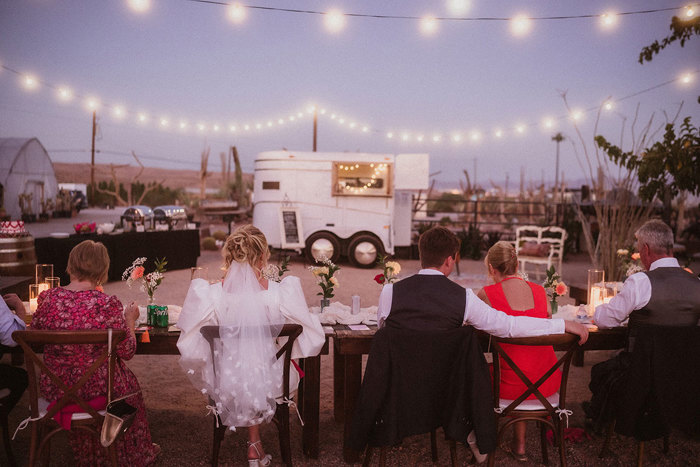wedding guests in the desert for dinner with food trucks after ceremony in las vegas