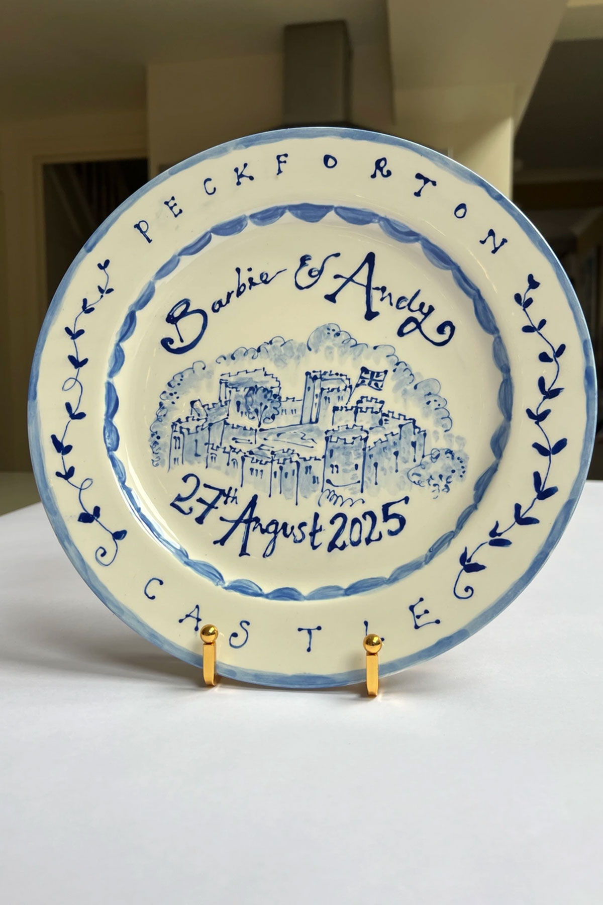 Personalised hand-painted wedding venue plate with couple names and date, a unique keepsake wedding gift idea