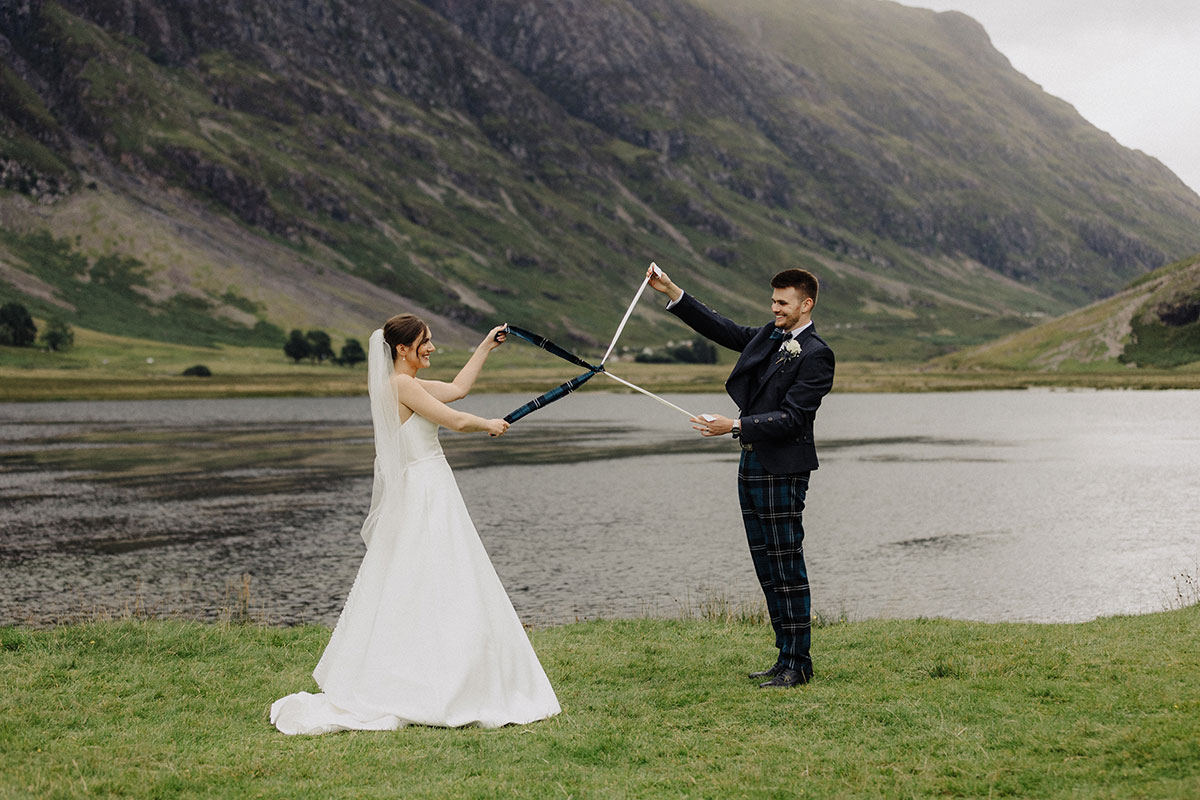 Couple handfasting by a loch