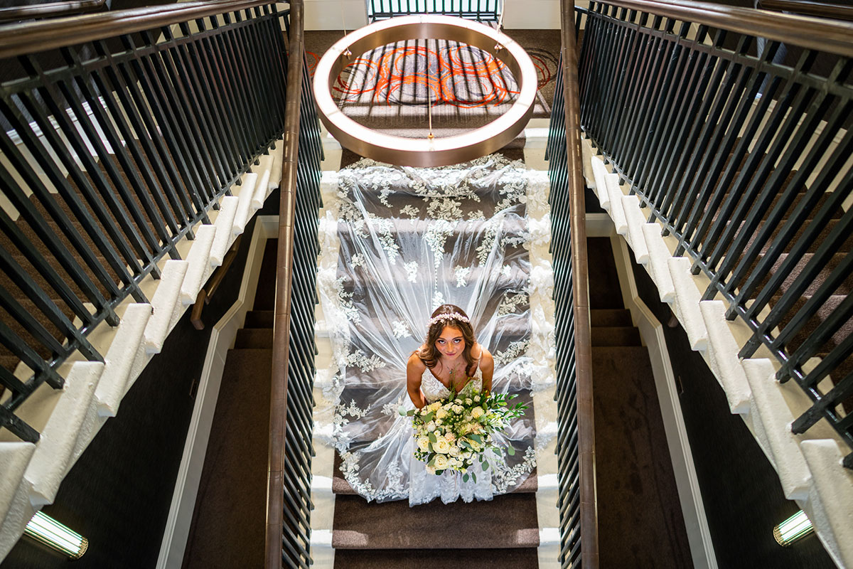 Bride on staircase looking up to camera