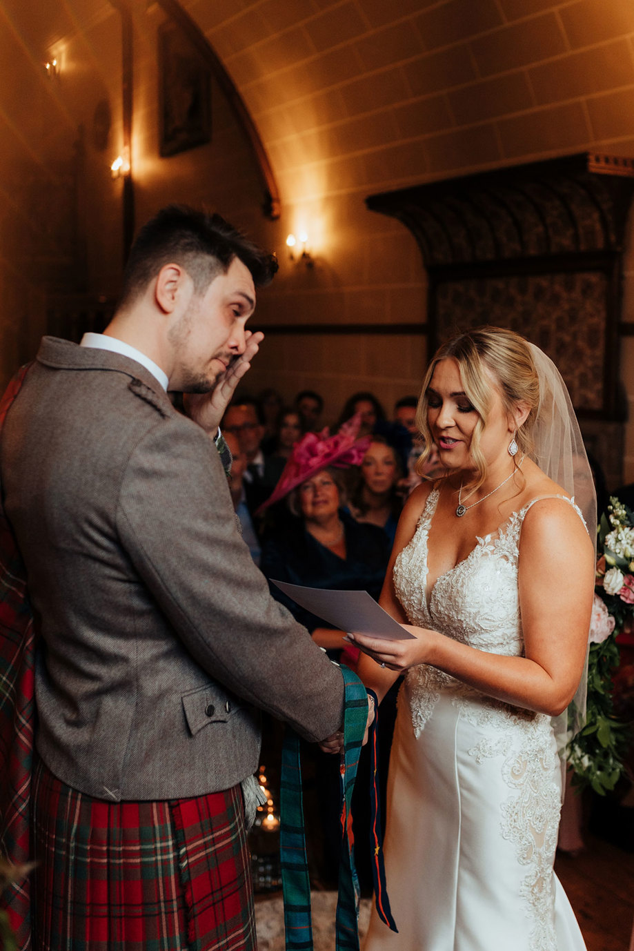 bride and groom look teary as they say vows at dalhousie castle