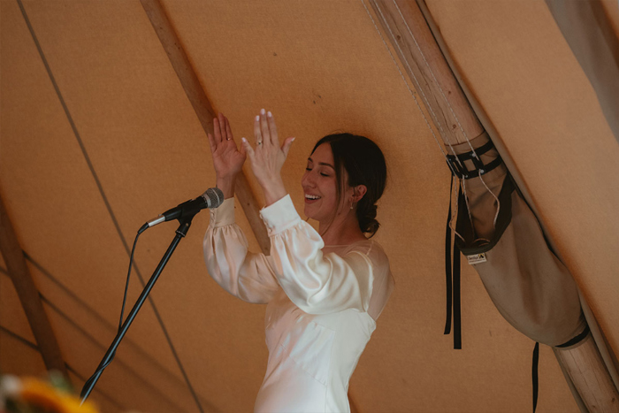 A Bride Cheering And Clapping During Her Wedding Speech In A Tipi
