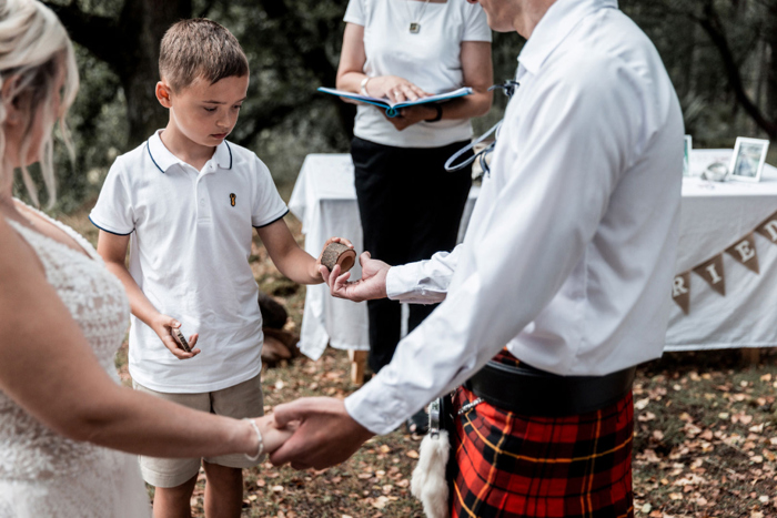 Small boy hands groom the ring box