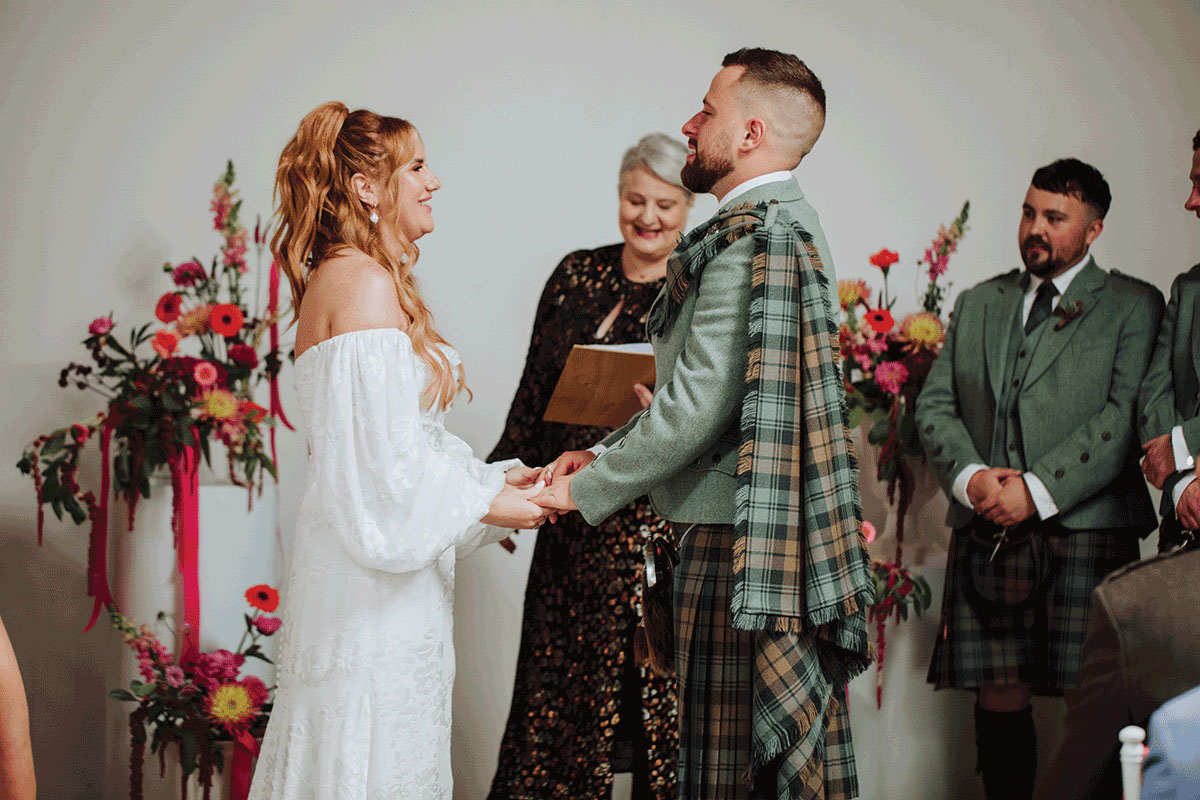 Scottish wedding ceremony at Backhouse Rossie with bride and groom exchanging vows led by Fuze Ceremonies celebrant Yvonne, surrounded by bright floral décor