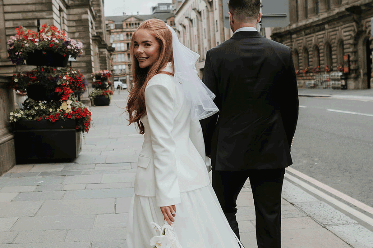 Bride and groom walking down glasgow street