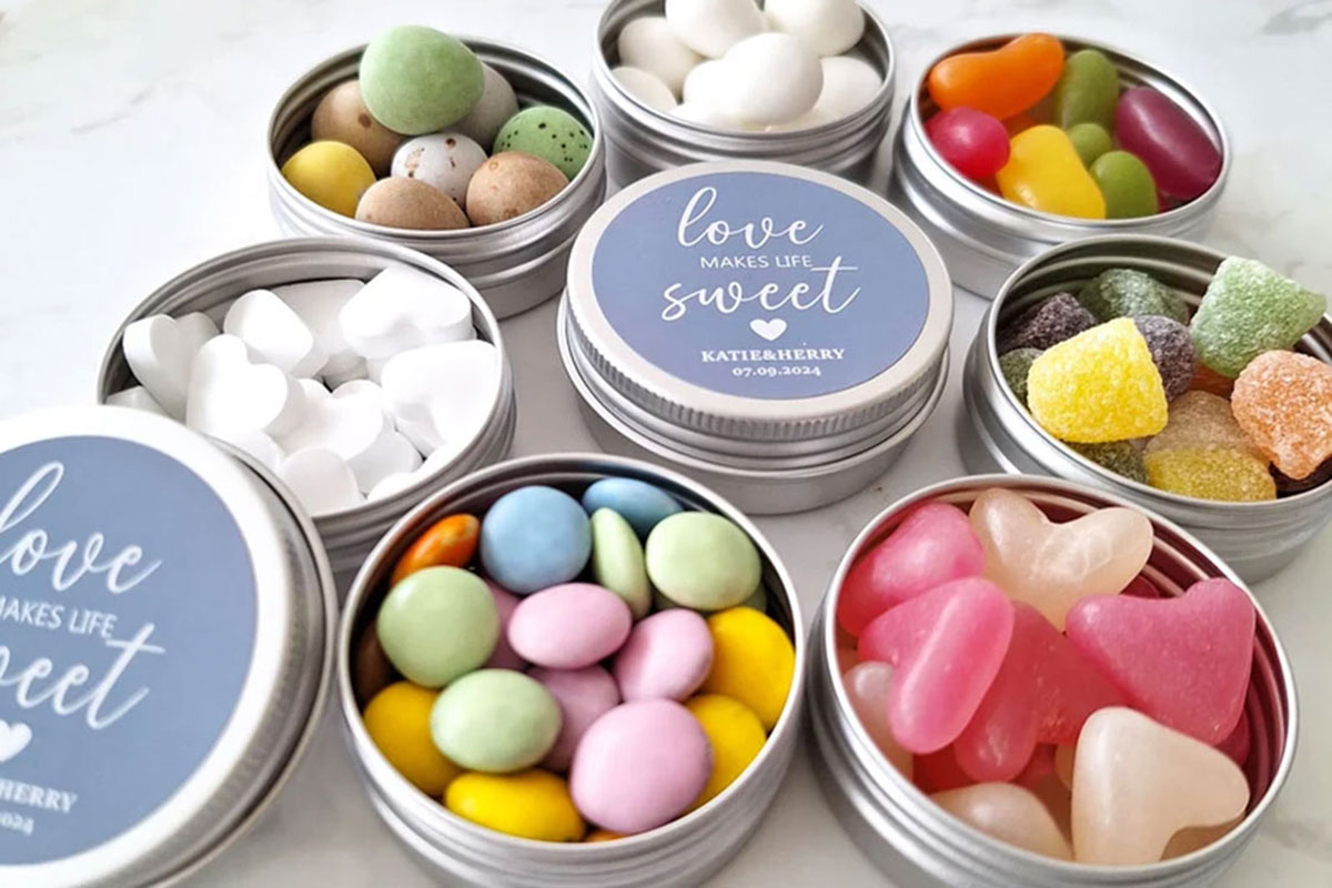 Small tins filled with colourful sweets as practical wedding favours