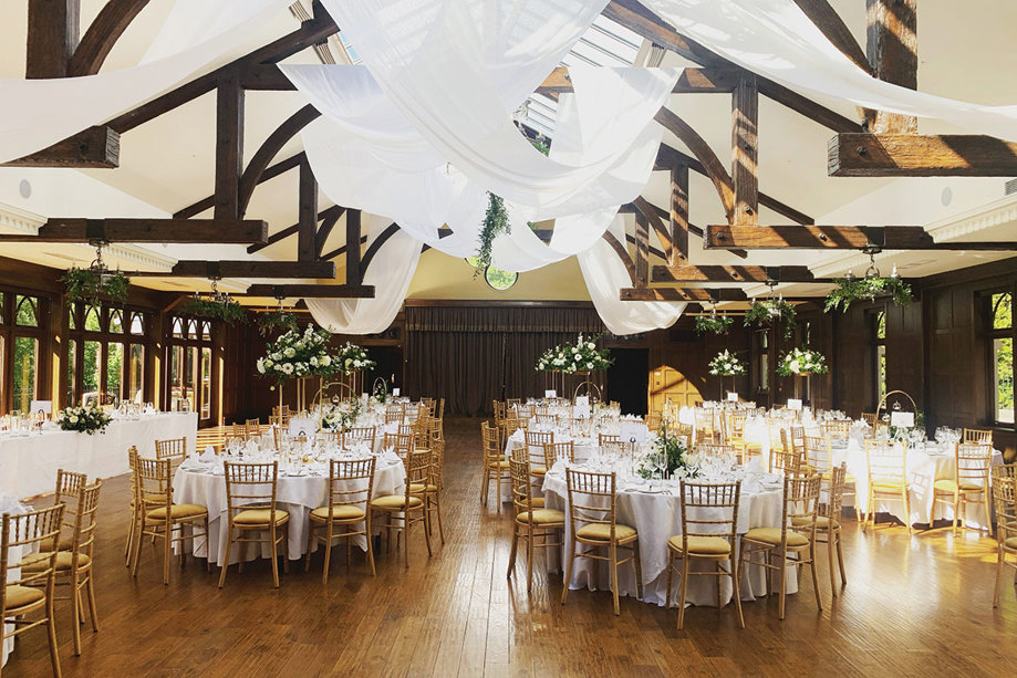 dinner set up with white table clothes and yellow seats at crossbasket castle