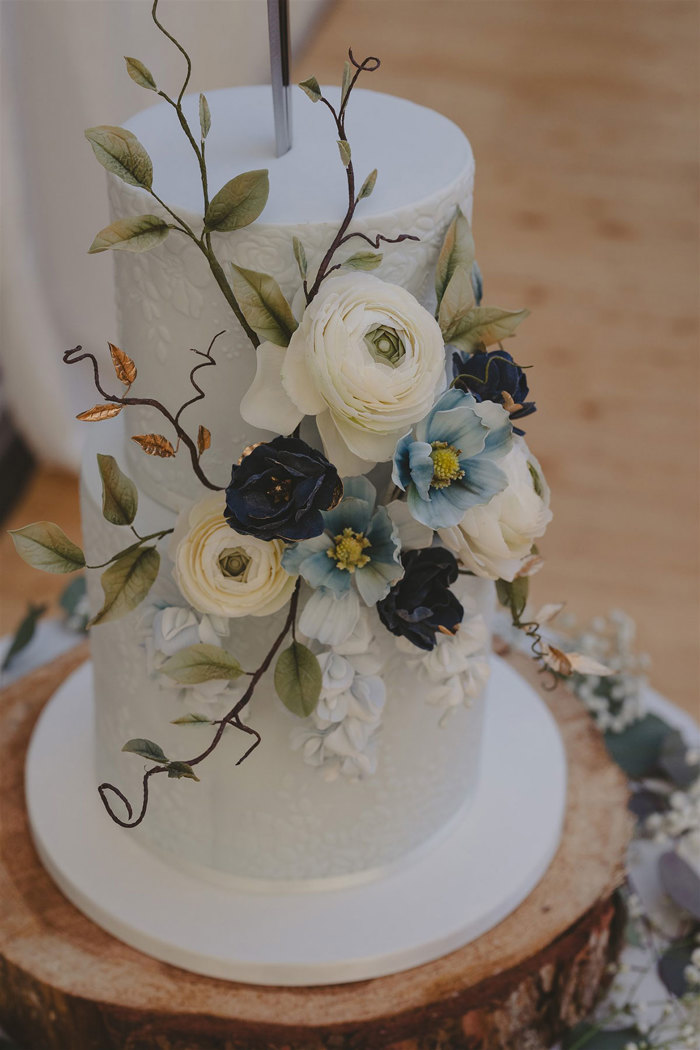 A white cake with flowers on top.