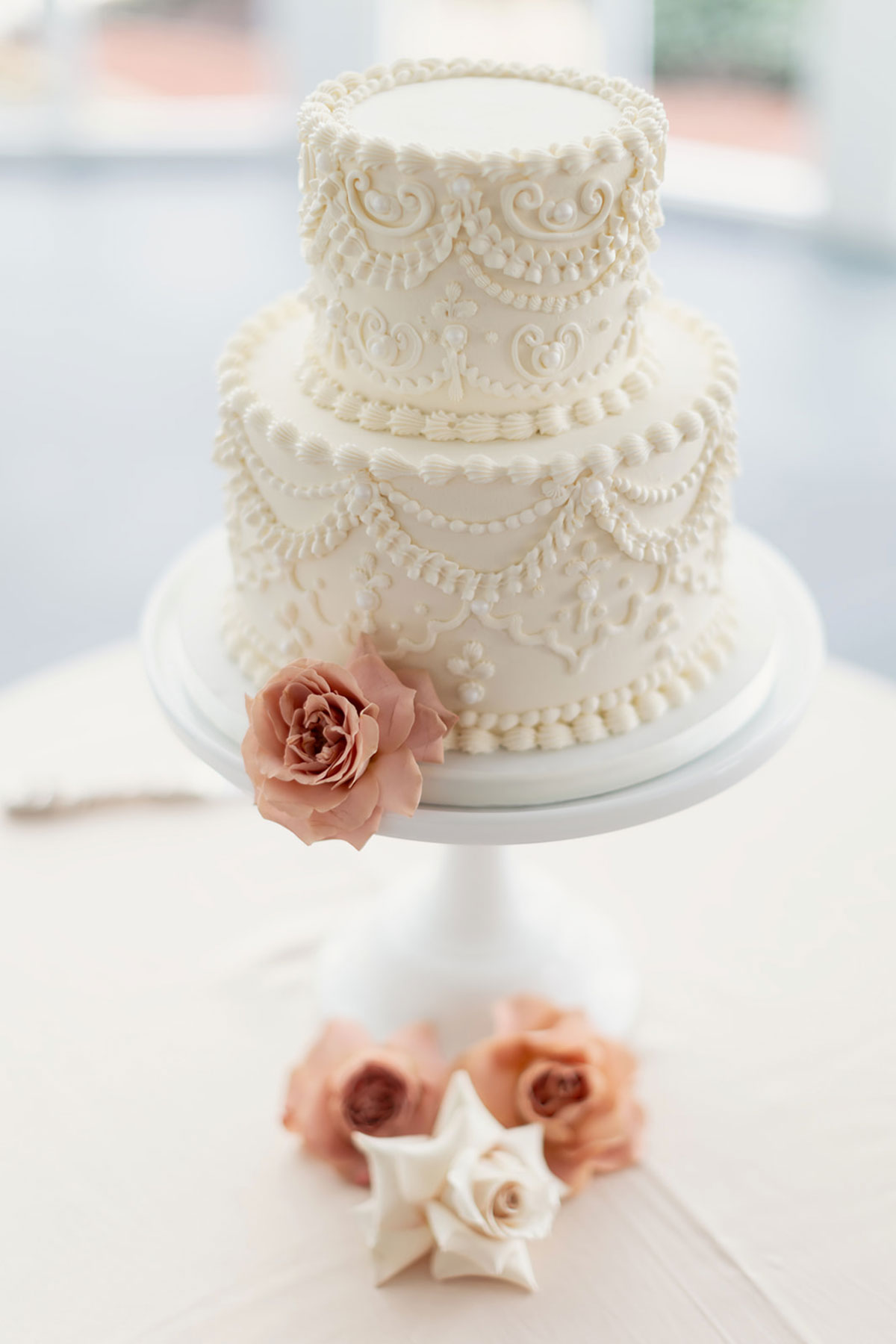 Liggy’s Cake Company two-tier white wedding cake with Lambeth piping and blush rose detail at Old Course Hotel, St Andrews