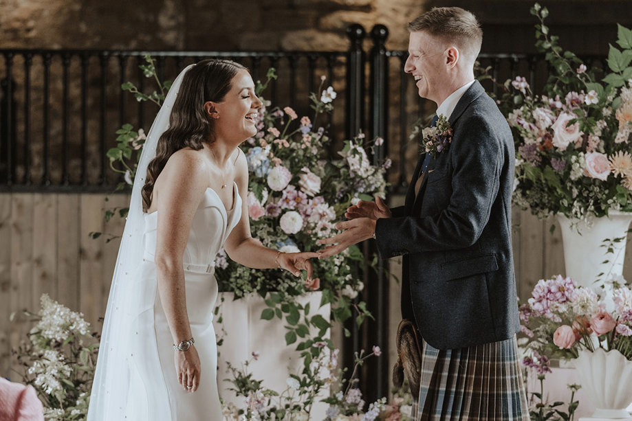 bride and groom say wedding vows at falside mill