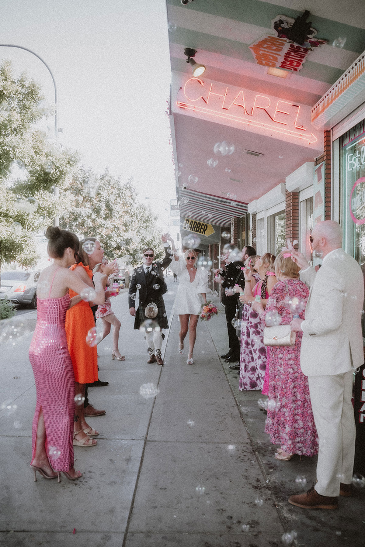 guests blow bubbles over bride and groom after wedding in las vegas
