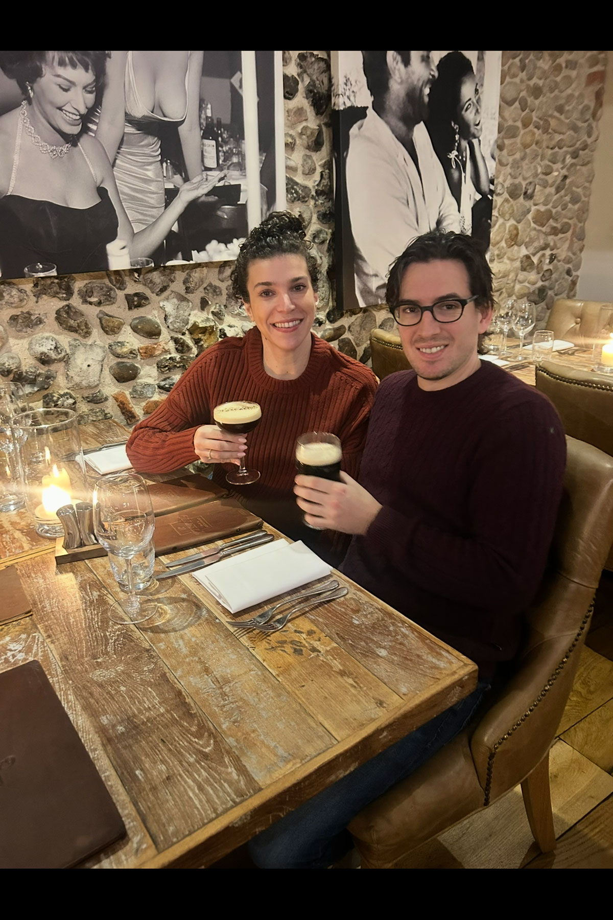 Couple enjoying drinks at restaurant table during pre-wedding celebrations