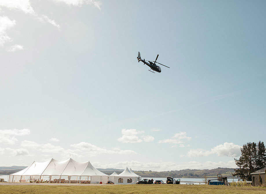 a helicopter flying over a wedding marquee at Loch Lomond