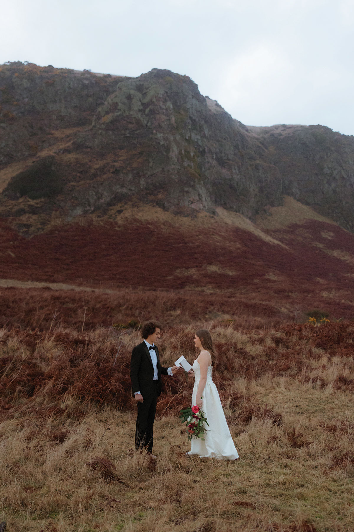bride and groom face one another and read wedding vows out loud