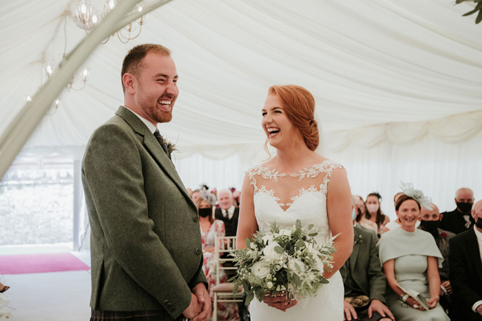 A Bride And Groom Laughing During A Wedding Ceremony At Cornhill Castle Photography By Megan Lannigan