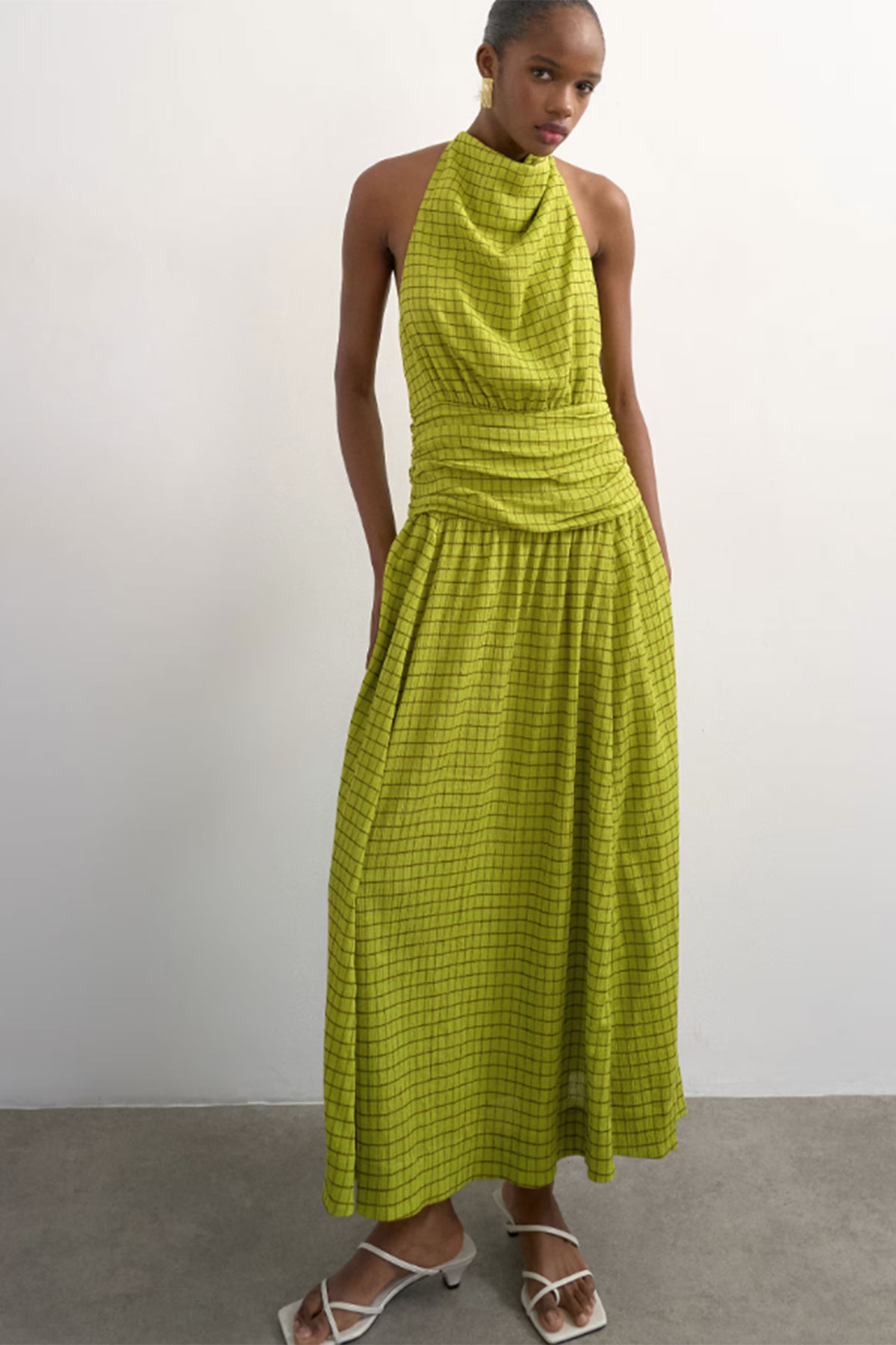 Lime green halterneck maxi dress with subtle check pattern and gathered waist