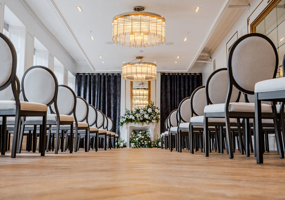 long shot of wedding aisle with seating and flowers on fireplace at the exchange