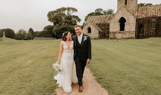 Alex and Matt Fagerson walking in grounds in front of Dunglass Collegiate Church on Dunglass Estate