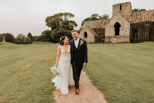 Alex and Matt Fagerson walking in grounds in front of Dunglass Collegiate Church on Dunglass Estate