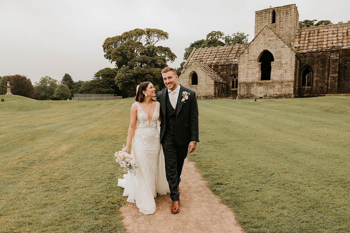 Alex and Matt Fagerson walking in grounds in front of Dunglass Collegiate Church on Dunglass Estate