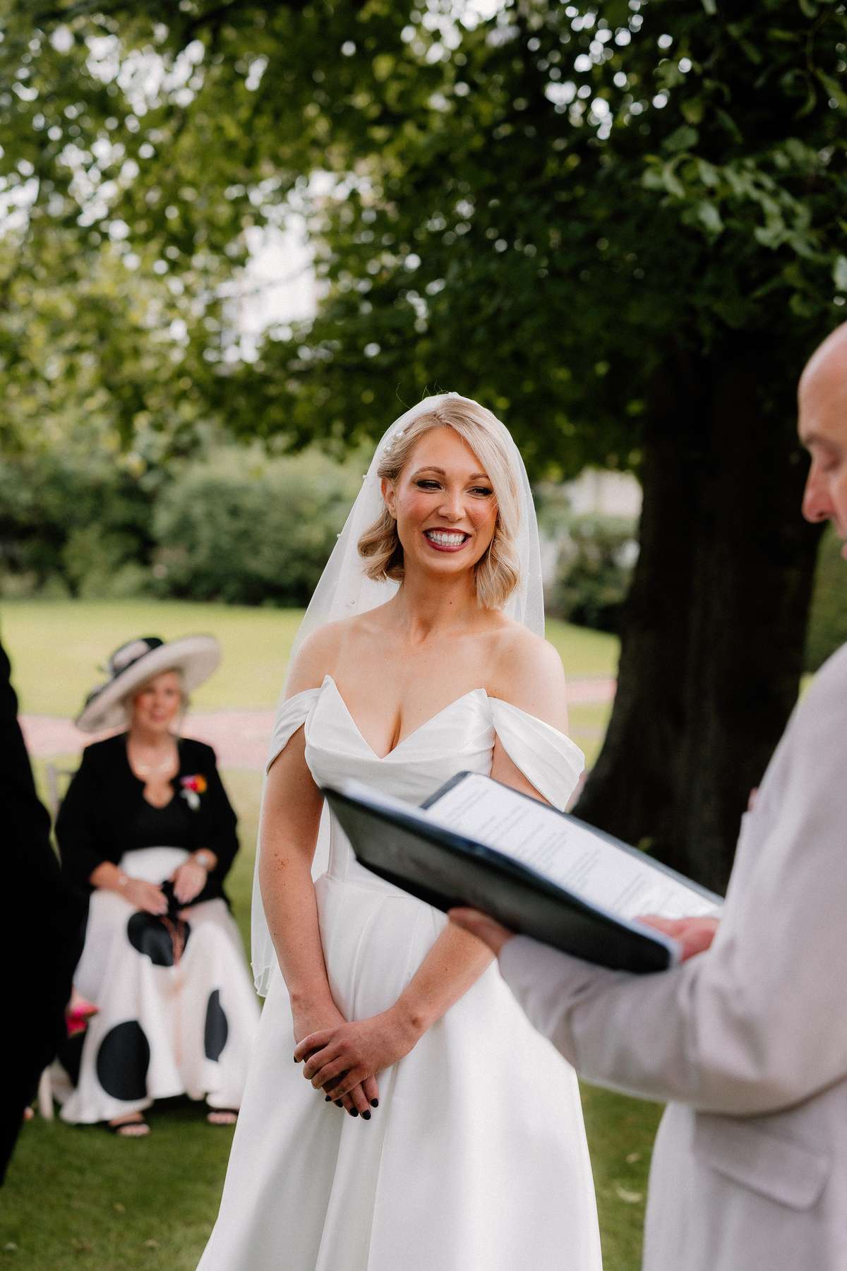 Bride Kara smiles during her intimate outdoor wedding ceremony in the grounds of Prestonfield House, Edinburgh.
