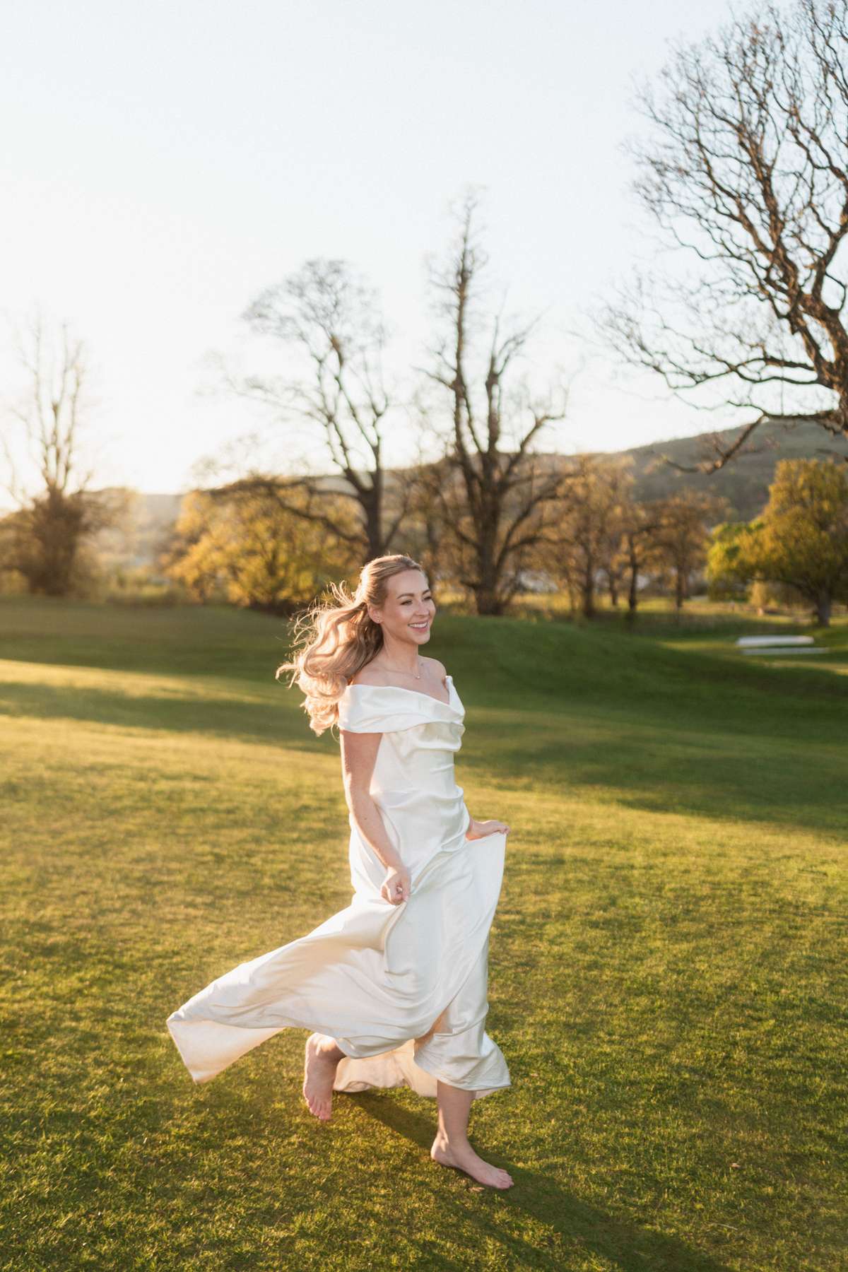 Bride Siân runs barefoot through the grounds of Mar Hall at golden hour in her Vivienne Westwood wedding dress.