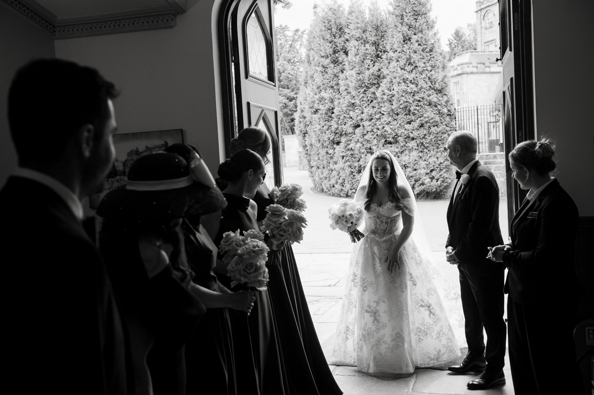 Bride arriving with her dad for her wedding ceremony in James Little Hall at Crossbasket Castle.