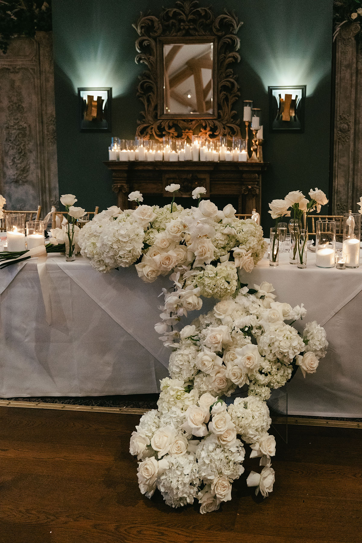 Top table wedding styling with cascading white floral arrangement and candles at Enterkine Country House