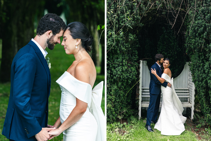 a bride and groom stand face to face with their eyes closed while holding hands on left and a groom kisses bride on cheek while standing in front of greenery and a wooden bench-like structure on right