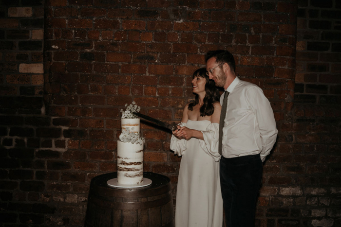 Couple cut their minimalistic wedding cake