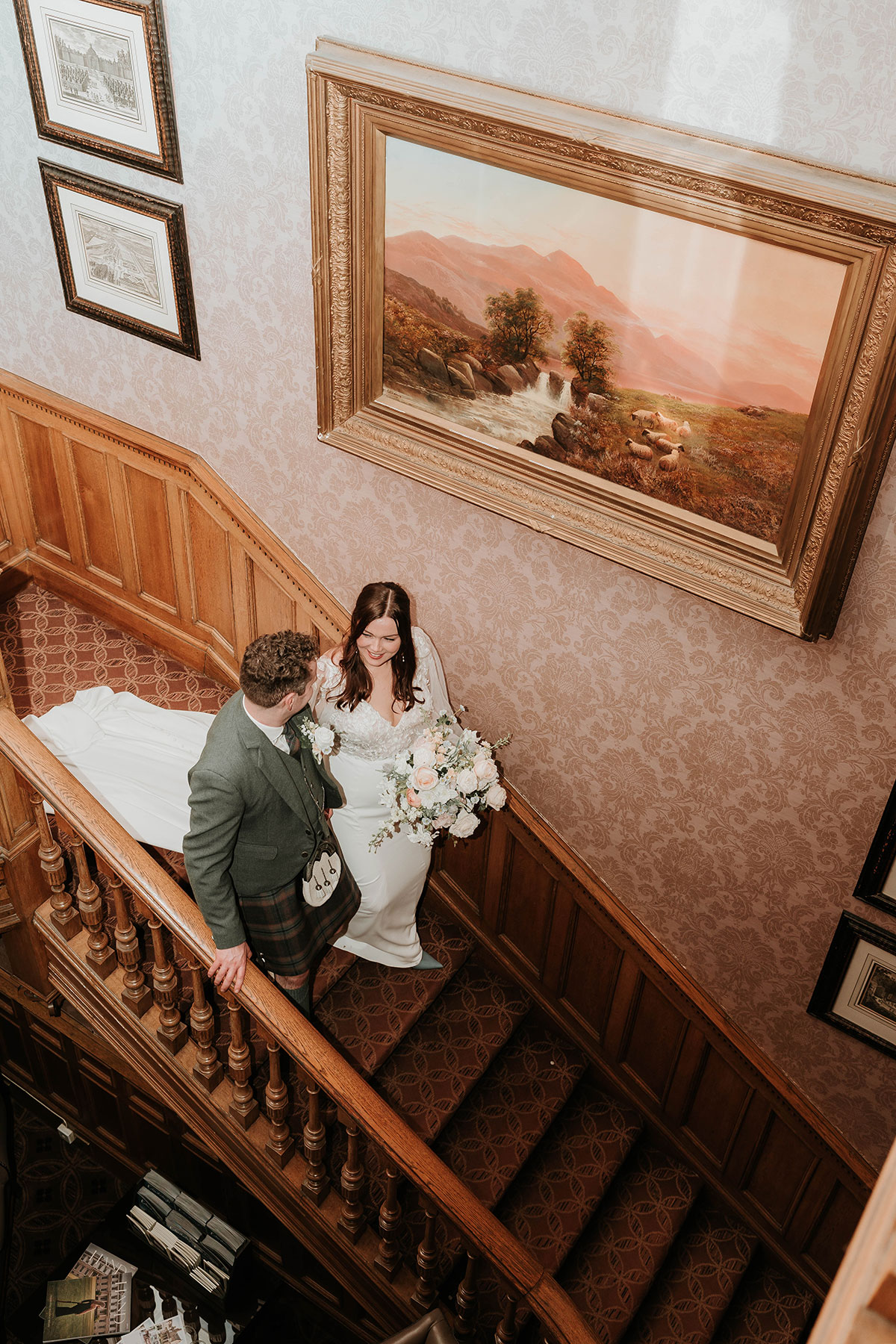 Overhead view of bride and groom walking up staircase