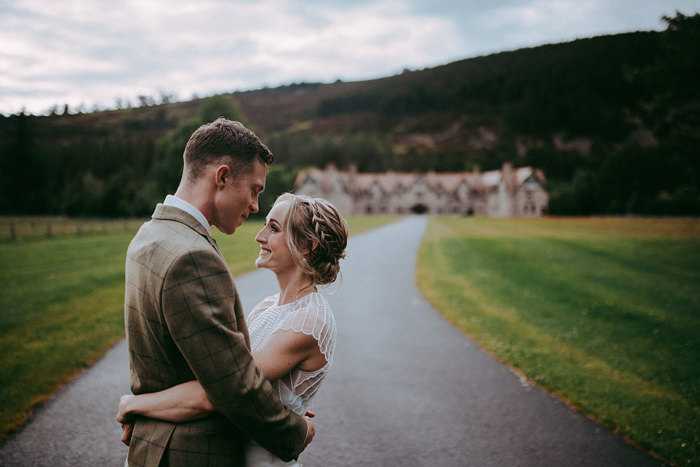 bride and groom standing in front of mar lodge