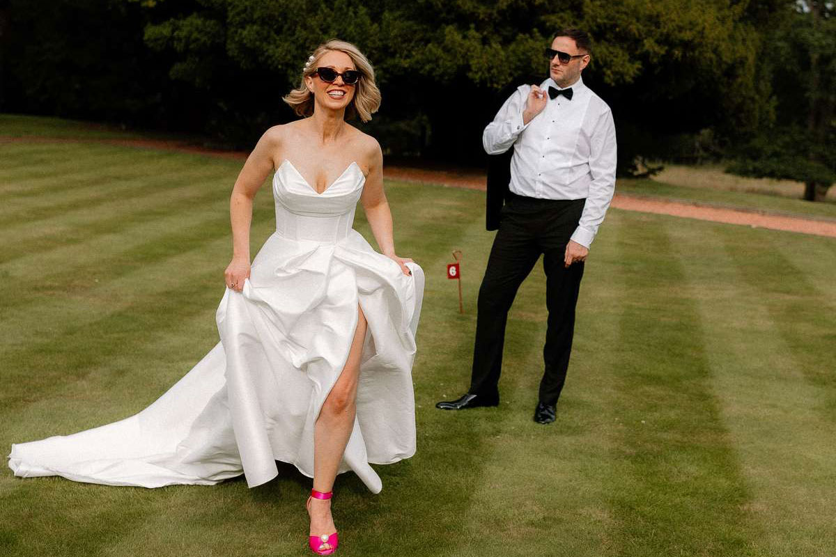 Kara and Rory have fun running during wedding portraits on the lawn at Prestonfield House in Edinburgh.