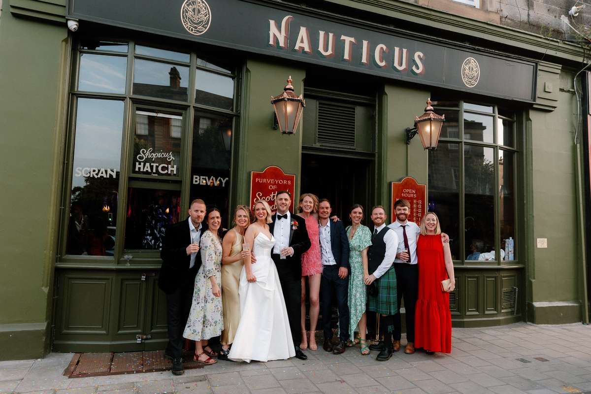 Kara and Rory pose with friends outside Nauticus in Leith during their Edinburgh wedding reception.