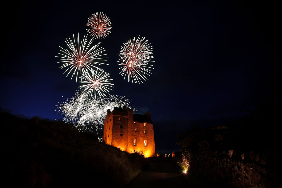 Fireworks display above Fenton Tower during an evening wedding celebration