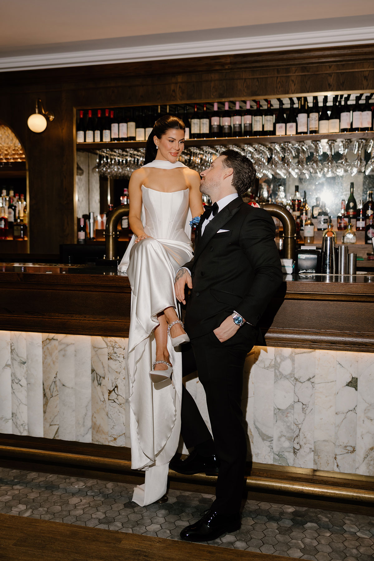Newlyweds posing at the bar during their The Exchange Glasgow wedding, sleek city-centre reception setting