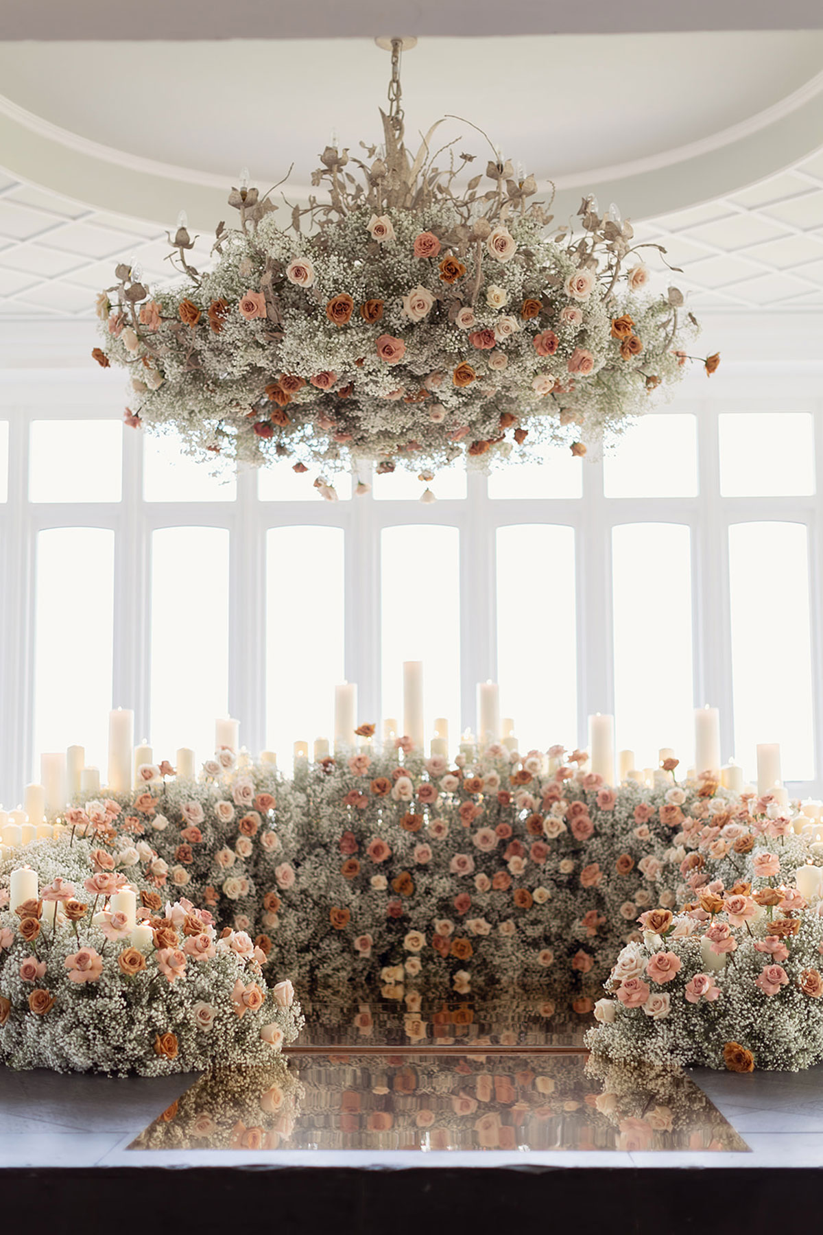 Autumn wedding ceremony styling with blush roses, baby’s breath, pillar candles and floral chandelier at Old Course Hotel St Andrews