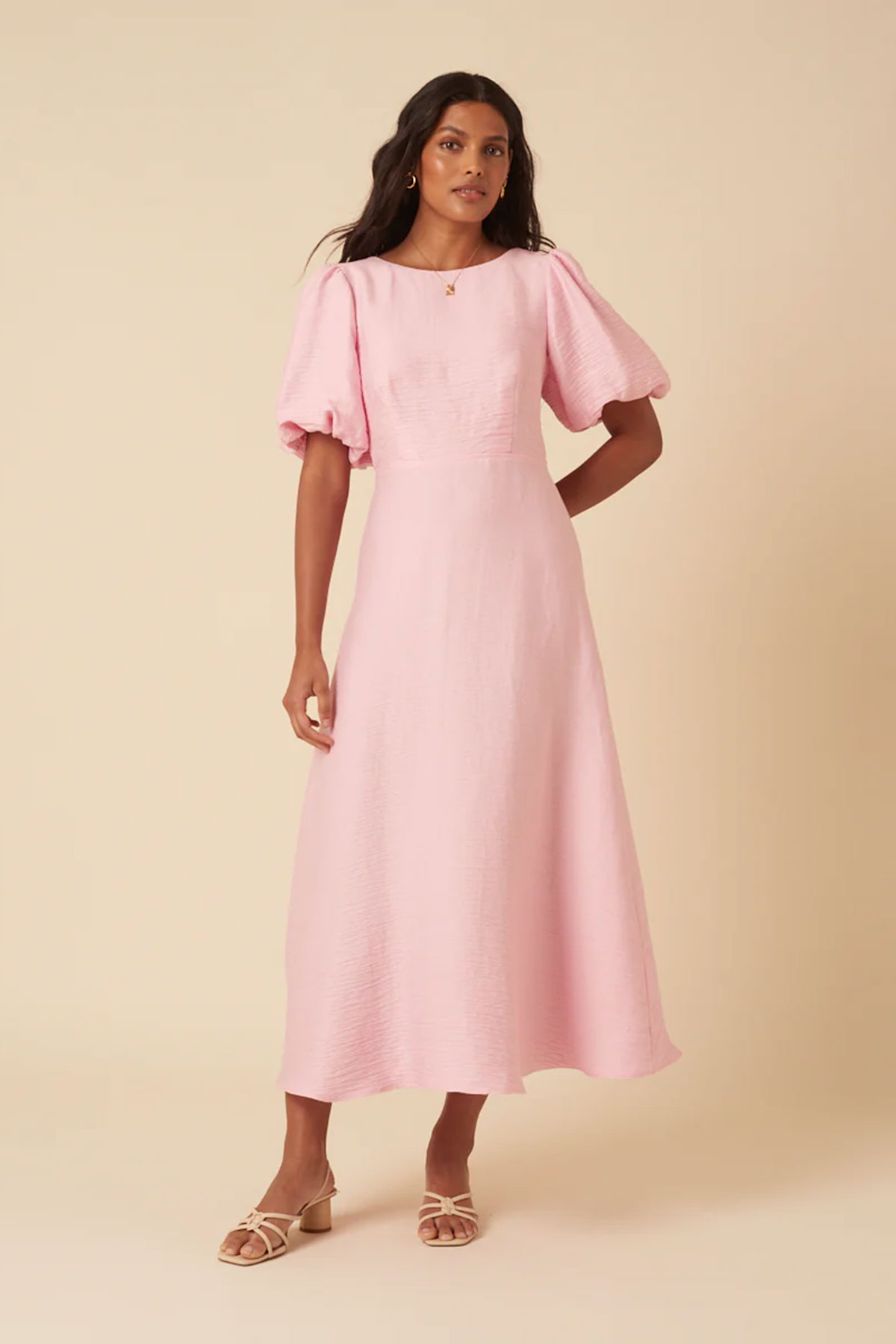 Blush pink midi dress with puff sleeves and fitted bodice styled with flat sandals 