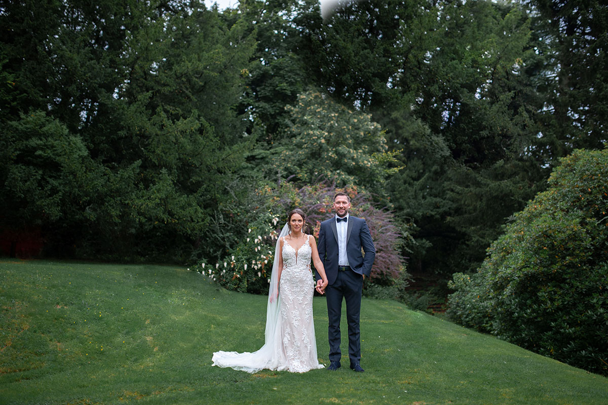 Couple standing on lawn at kilmardinny house
