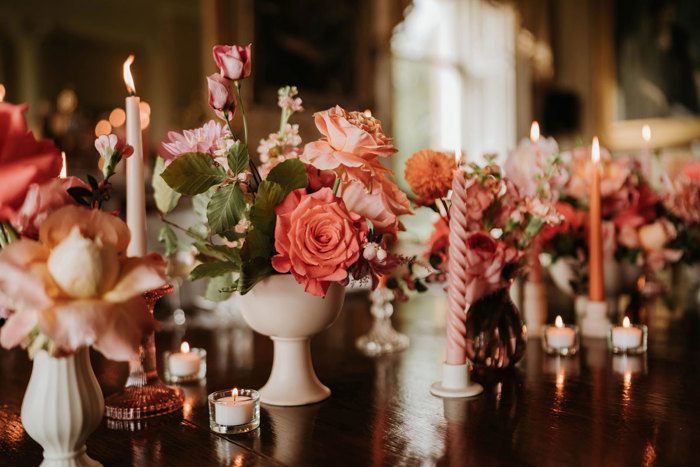 A dining table display of pink bouquets and candlesticks